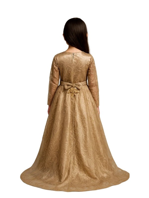 Woman wearing a long, gold dress with a bow detail on a white background