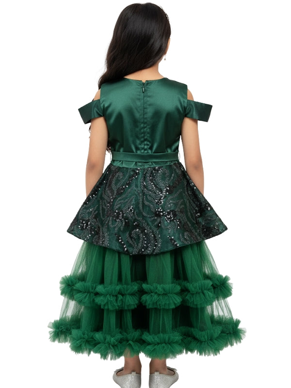 Green dress with sequin detailing and ruffled skirt on a white background
