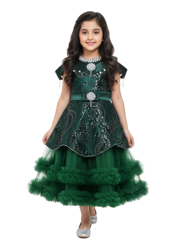 Young girl wearing a green dress with sequins on a white background