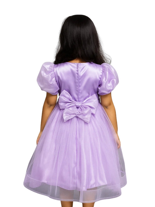 Lavender dress with a large bow on the back, worn by a person.