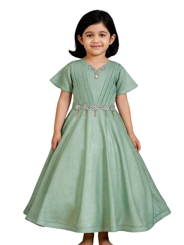 Young girl wearing a green dress with a belt on a white background