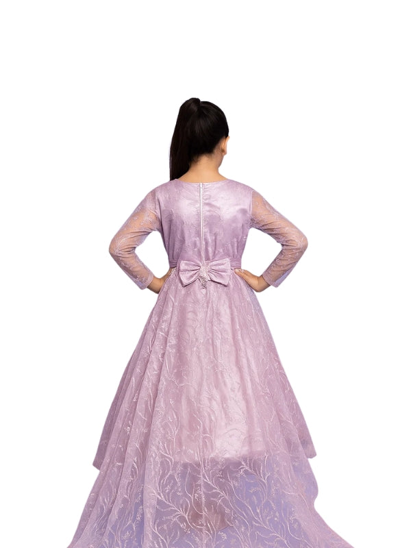 Woman wearing a light purple gown with a bow detail on a white background