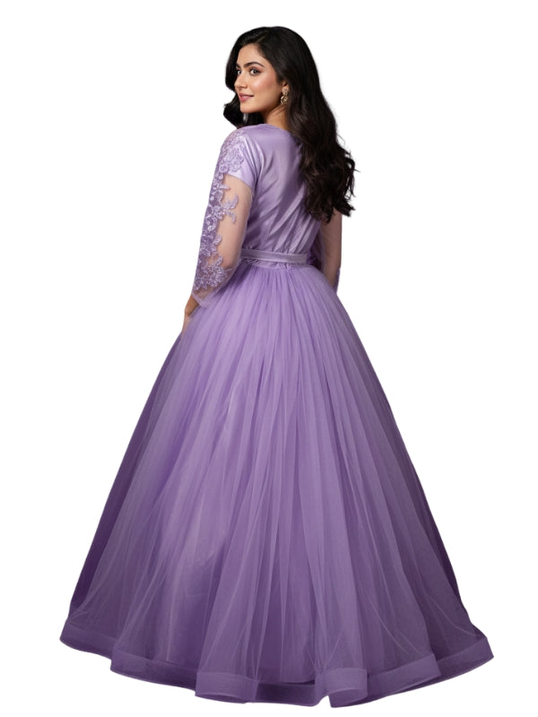 Woman wearing a purple gown with floral embellishments on a white background