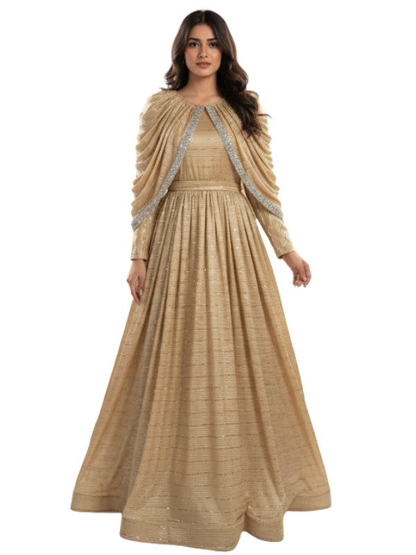 Woman wearing a beige long dress with silver detailing on a white background